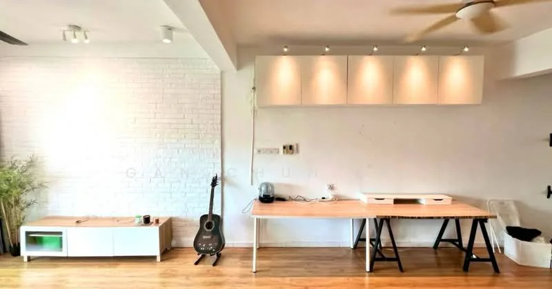 Living features: white painted walls, exposed brick accent wall, wood flooring, ceiling fan, recessed downlights, built-in cabinetry with lighting, wooden table, guitar, open shelving, decorative plant, freestanding cabinet; style: modern.