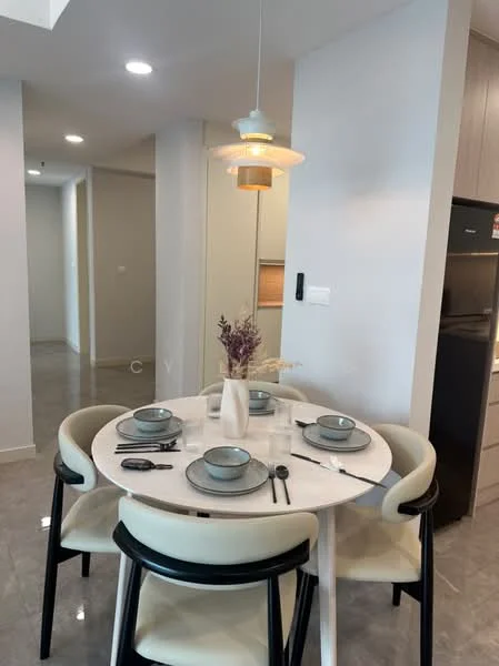 Dining features: round dining table, 4 upholstered dining chairs, ceramic plates, cutlery, glass vase with dried flowers, pendant lamp, grey tile flooring, white walls, built-in cabinetry in background, refrigerator visible in background; style: modern.