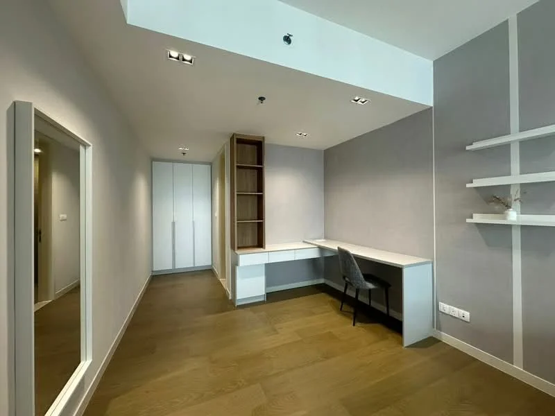Study features: light wood flooring, grey accent wall, white painted walls, built-in shelving, desk with chair, floor-to-ceiling mirror, built-in wardrobe, recessed downlights; style: modern.
