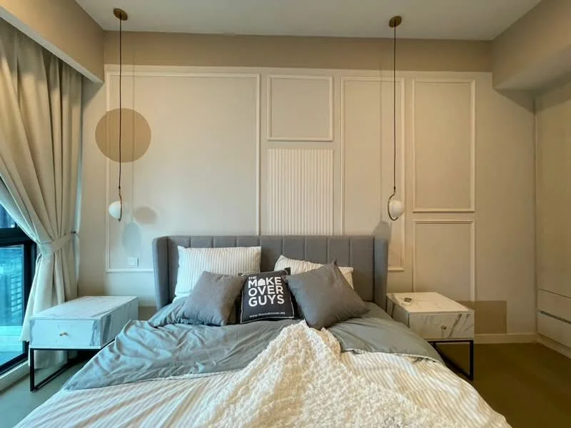 Bedroom features: king-size bed with grey upholstered headboard, white and grey bedding, two bedside tables with marble tops, pendant lights hanging from the ceiling, decorative throw pillows, wall with paneling design, floor-to-ceiling windows, curtains in light fabric, neutral wall color, carpeted flooring; style: modern.
