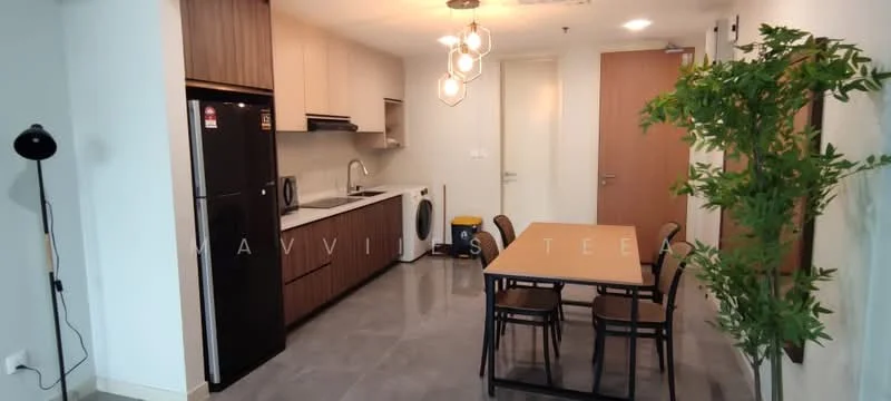 Kitchen features: black fridge, built-in oven, microwave, white washing machine, grey countertop, wood cabinetry, 4-seater dining table, black dining chairs, pendant lighting, grey tile flooring, green potted plant, wall-mounted light, open layout, floor-to-ceiling windows; style: modern.