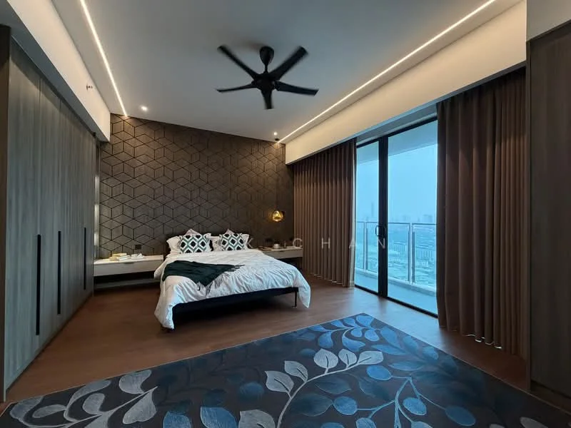 Bedroom features: king-size bed with white bedding, upholstered headboard, 2 bedside lamps, built-in wardrobe with sliding doors, geometric accent wall in dark tones, floor-to-ceiling windows, sliding glass door to balcony, dark wood flooring, 5-blade ceiling fan, sheer curtains, decorative area rug with floral pattern; style: modern; view: city.