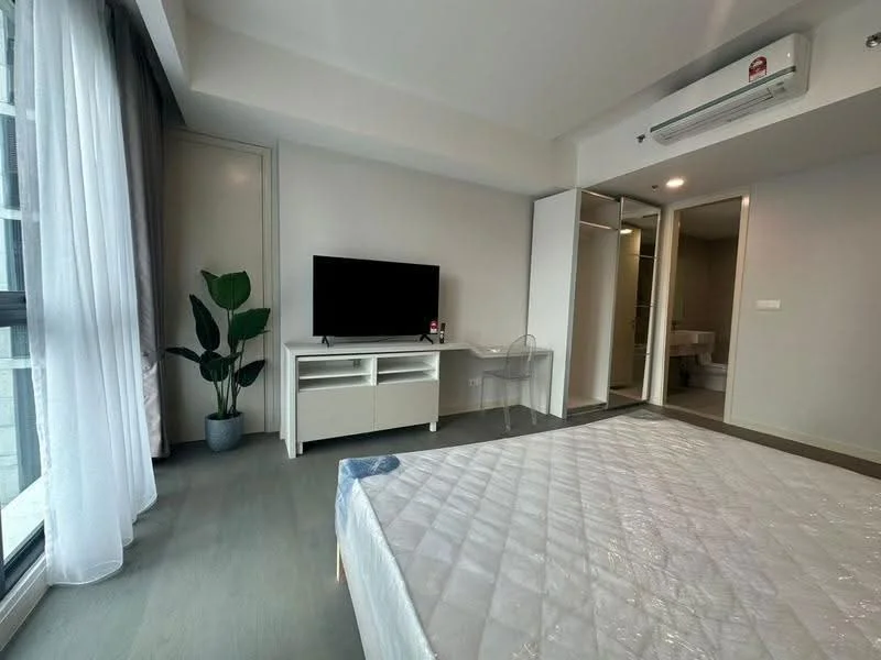 Bedroom features: queen-size bed, white bedding, floor-to-ceiling windows, light grey walls, wooden flooring, wall-mounted TV, white TV console, transparent chair, indoor plant, built-in wardrobe, air conditioning unit, curtains, recessed lighting; style: modern; view: city.