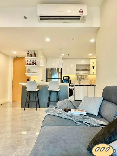 Living features: grey fabric sofa, coffee table, marble tile flooring, wall-mounted split AC, pendant lighting, open shelving with bottles, kitchen island with seating, refrigerator, built-in oven, microwave, washer-dryer combo, white cabinetry, grey countertop, backlit cabinetry; style: modern.