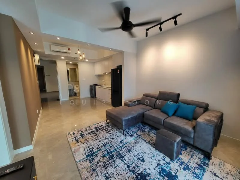 Living features: L-shape sectional sofa in grey, blue accent cushions, area rug with abstract pattern, ceiling fan, recessed downlights, wall-mounted TV, light grey walls, polished concrete flooring; style: modern. Kitchen features: kitchen cabinets, stainless-steel fridge, built-in oven, countertop, open layout; style: modern.