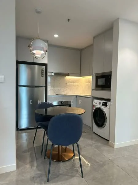 Kitchen features: grey cabinetry, white marble backsplash, black countertop, stainless-steel fridge, built-in microwave, front-load washing machine, round dining table, blue upholstered dining chairs, pendant light fixture, ceramic tile flooring, recessed lighting; style: modern.