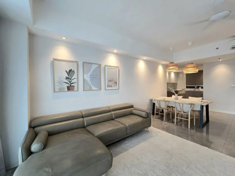 Living features: 3-seater leather sofa in light grey, area rug with neutral color, framed artwork on walls, recessed downlights, pendant lights above dining area, open layout to dining area, polished tile flooring, ceiling fan; style: modern. Dining features: 6-seater dining table, wooden dining chairs, pendant lighting above table, open layout to living area, neutral color scheme; style: modern.