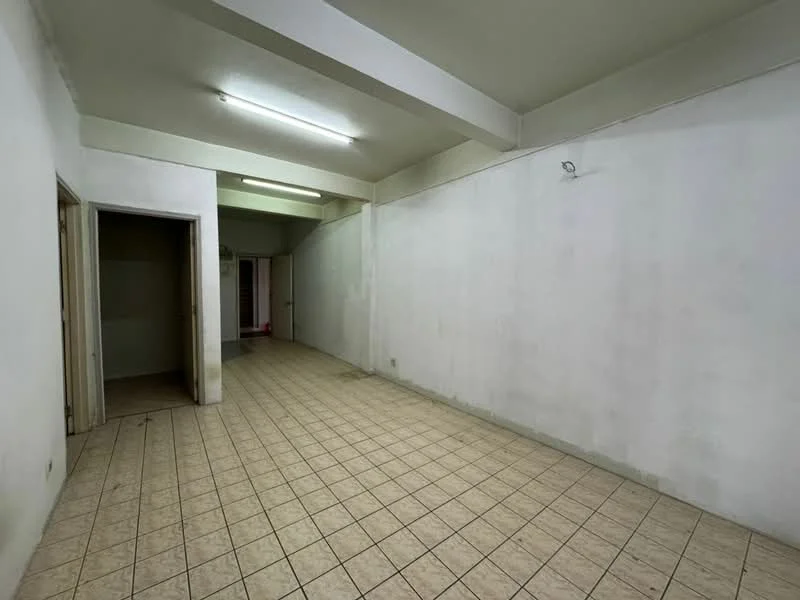 Room features: white painted walls, tile flooring, fluorescent ceiling lights, open layout, no visible furniture, doorway leading to another room, doorway leading to hallway, plain ceiling; style: minimalist.
