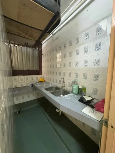 Kitchen features: double-bowl stainless-steel sink, chrome pull-down faucet, grey tiled countertop, white tiled walls with decorative pattern, green vinyl flooring, built-in cabinetry, window with metal grille, overhead storage, kitchen utensils on countertop.