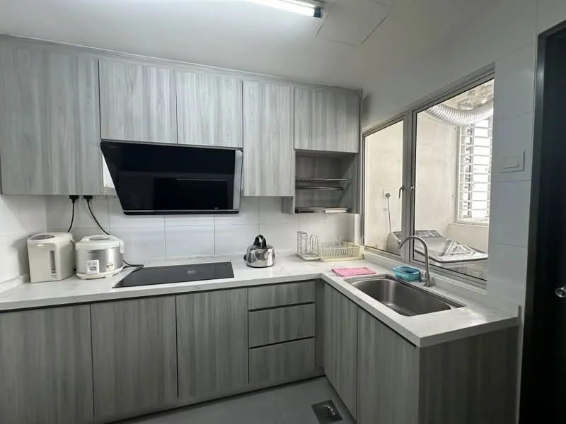 Kitchen features: grey laminate cabinetry, white quartz countertop, built-in induction cooktop, wall-mounted flat-screen TV, stainless-steel sink, chrome pull-down faucet, kettle, toaster, dish rack, window with view of external area, grey tiled flooring, recessed ceiling lights; style: modern.