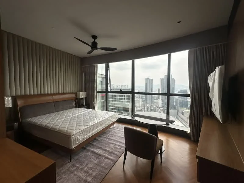 Bedroom features: king-size bed, upholstered headboard, wooden bedside tables, floor-to-ceiling windows, city skyline view, ceiling fan, wall-mounted TV, wooden flooring, decorative area rug, armchair, round coffee table, curtains, accent wall with vertical panels; style: modern; view: city.