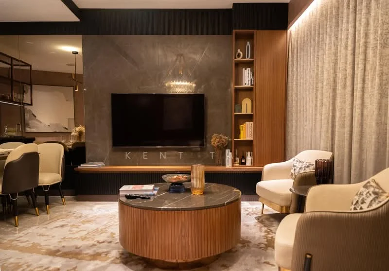 Living features: wall-mounted TV, round coffee table with marble top, upholstered armchairs in cream, wooden side table, decorative vase, soft area rug with geometric pattern, recessed lighting, feature wall with dark paneling, built-in shelving unit, chandelier, curtains, decorative books; style: modern.
