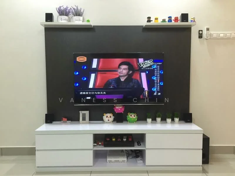 Living features: white TV console, wall-mounted flat-screen TV, dark accent wall, decorative plants on console, shelves with decorative items, ceramic figurines, neutral tiled flooring, wall-mounted light switch; style: modern.