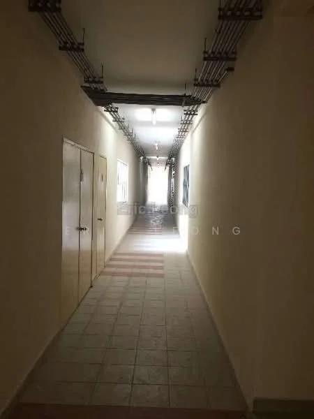 Hallway features: tiled flooring, cream painted walls, fluorescent ceiling lights, exposed electrical conduits, windows along one side, double doors at one end, striped floor pattern, neutral color scheme.