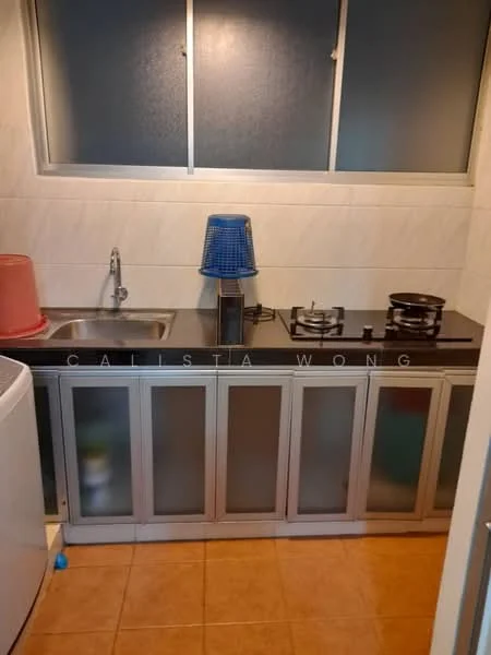 Kitchen features: single-bowl stainless-steel sink, chrome faucet, black countertop, two-burner gas hob, metal cooking pots, grey cabinetry with glass panels, tile backsplash, cream tiled walls, brown tiled flooring, window with frosted glass, blue lamp; style: modern.