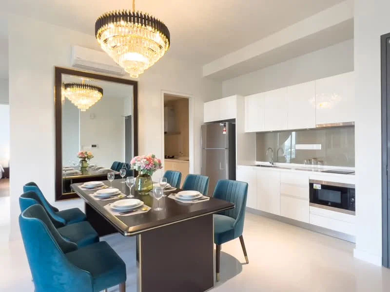 Dining features: 8-seater dining table with black surface, upholstered dining chairs in teal, chandelier with crystal accents, large wall mirror, white cabinetry, stainless-steel fridge, built-in microwave, kitchen countertop with backsplash, recessed downlights, light-colored flooring; style: modern. Kitchen features: white cabinetry, stainless-steel fridge, built-in microwave, kitchen countertop with backsplash, recessed downlights; style: modern.
