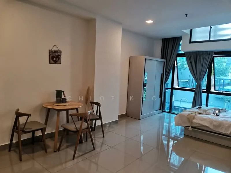 Room features: white painted walls, grey tiled flooring, large windows with sheer curtains, bed with white bedding, round dining table, two wooden chairs, built-in wardrobe, refrigerator, decorative wall sign, ceiling light fixture; style: modern; view: pool.