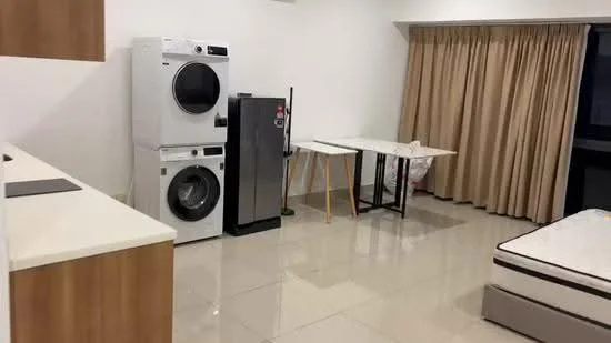 Room features: white painted walls, glossy tile flooring, washing machine, tumble dryer, stainless-steel fridge, folding table, curtains, mattress on bed frame; style: modern.