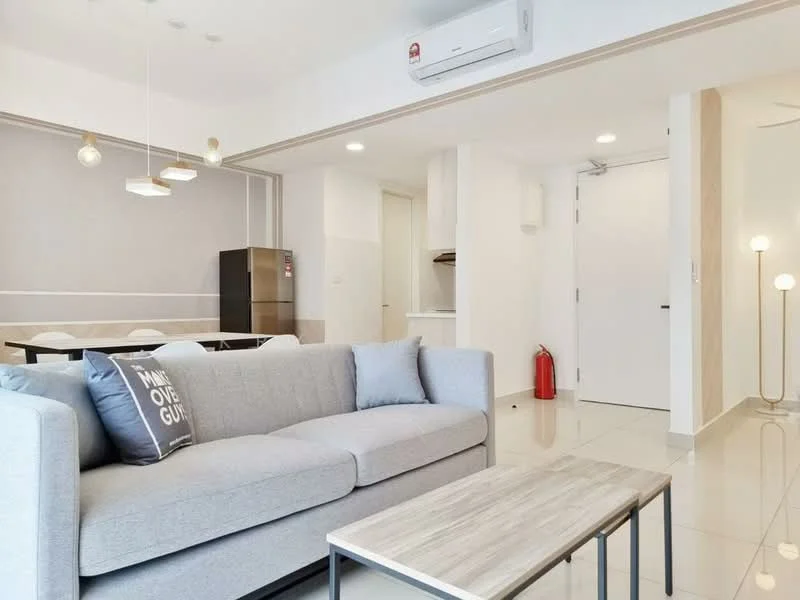 Living features: grey fabric sofa, coffee table with wooden top, 5-blade ceiling fan with light, wall-mounted air conditioning unit, white walls, tile flooring, floor-to-ceiling windows, decorative floor lamp, dining area visible in background, fire extinguisher on wall, open layout to kitchen, light fixtures with multiple bulbs; style: modern. Kitchen features: stainless-steel fridge, open kitchen layout, white cabinetry, countertop, kitchen appliances visible; style: modern.
