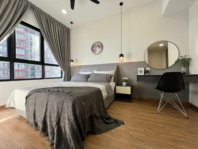 Bedroom features: king-size bed with grey bedding, upholstered headboard, 2 pendant lights hanging above the bed, wooden flooring, floor-to-ceiling windows, grey curtains, round mirror on wall, black desk with chair, decorative plant on desk, wall art with moon design; style: modern; view: city.