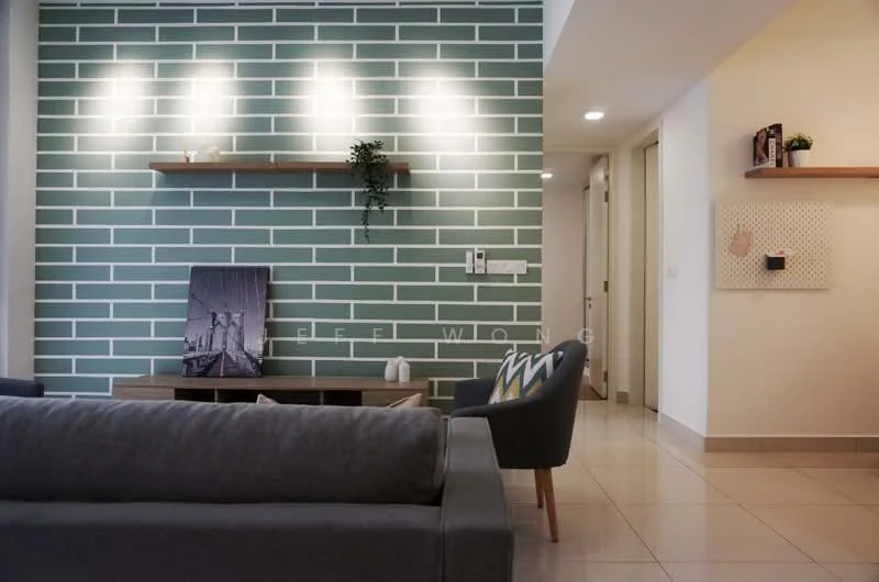 Living features: grey fabric sofa, wood coffee table, green accent wall with white brick pattern, shelves on wall, decorative plant on shelf, framed artwork, tile flooring, recessed downlights; style: modern. Room features: white painted walls, doorway leading to other rooms, light switch panels.