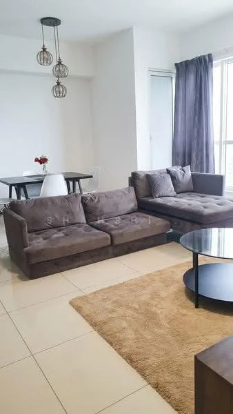 Living features: L-shape sectional sofa in grey fabric, round coffee table with black base, area rug in beige, floor-to-ceiling windows, curtains in dark grey, pendant lighting with three bulbs, decorative vase with flowers on table, cream painted walls, tile flooring in light color; style: modern; view: city.