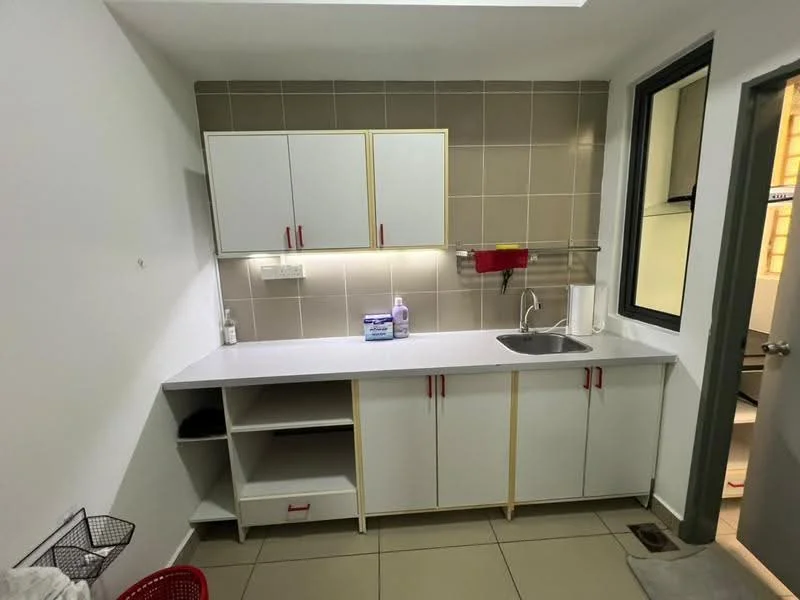 Laundry features: white cabinetry with gold handles, grey tiled backsplash, white countertop, single-bowl stainless-steel sink, chrome faucet, built-in shelving, grey floor tiles, window with black frame, basket for laundry, red storage basket; style: modern.