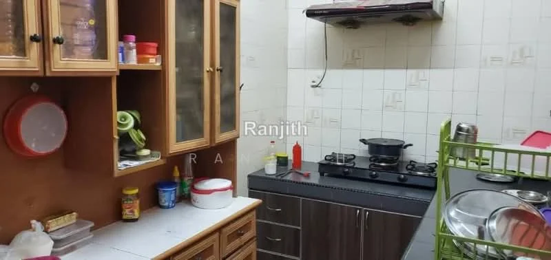Kitchen features: wood cabinetry with glass doors, white tiled walls, grey countertop, 4-burner gas hob, exhaust hood, stainless-steel pot, plastic containers, sauce bottles, sink, kitchen utensils, open shelving, wall-mounted storage rack.