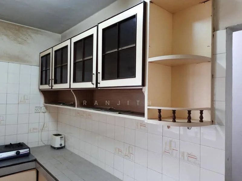 Kitchen features: wall-mounted cabinets with glass doors, cream cabinetry, brown wooden shelving, white tiled walls, grey countertop, gas stove, toaster, open shelving, tile flooring.