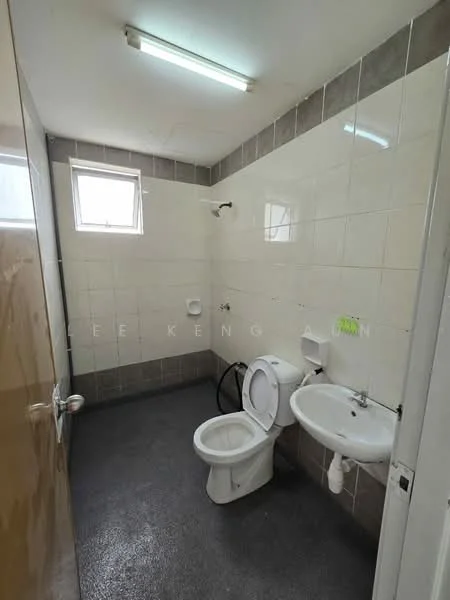 Bathroom features: white tiled walls, grey tiled flooring, single-sink vanity, chrome basin mixer faucet, one-piece toilet, shower head, window for natural light, ceiling light fixture.
