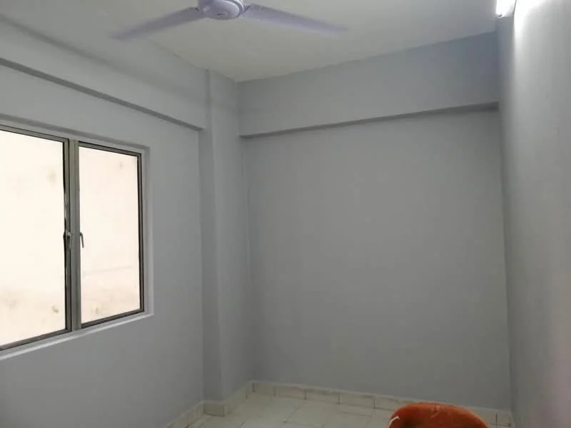 Room features: light grey painted walls, white ceiling, single window with white frame, tile flooring, ceiling fan, corner of an orange chair.