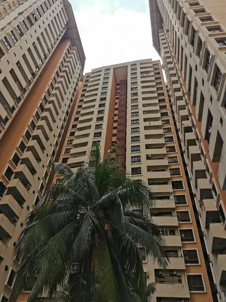 Exterior type: high-rise condominium; features: concrete facade with beige and orange accents, multiple storeys, balconies visible on several floors, large windows, palm tree in foreground, urban setting, surrounded by other high-rise buildings; style: modern.