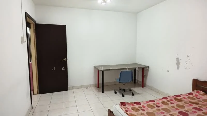 Bedroom features: white painted walls, tiled flooring, single bed with mattress, wooden bed frame, study desk with red legs, blue office chair, door leading to hallway, ceiling light fixture.