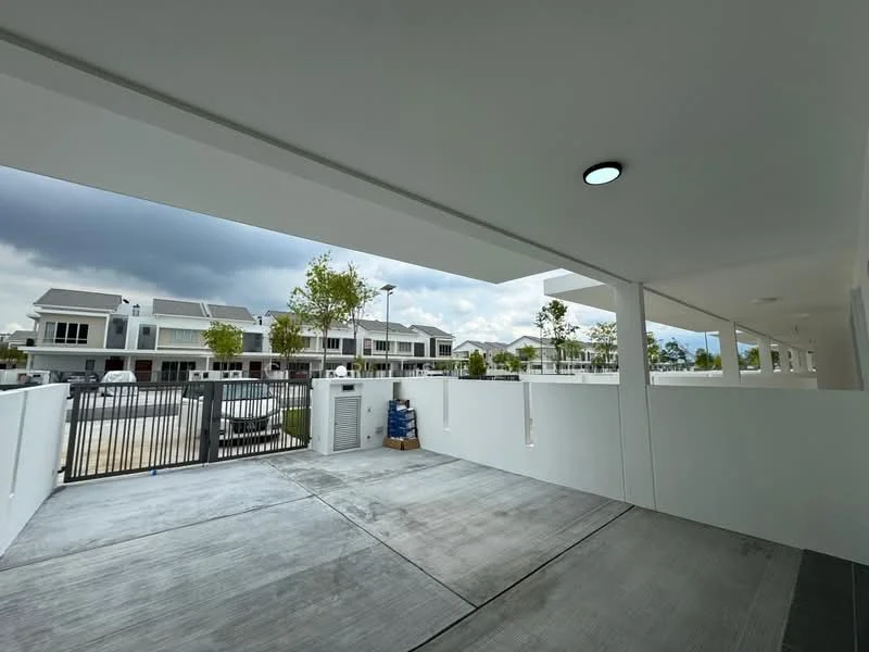 Exterior type: linked terrace house; features: white painted facade, flat roof, manicured lawn, gated entry with security gate, driveway with interlocking pavers, surrounded by mature greenery, parking area visible, multiple units in view; style: modern.
