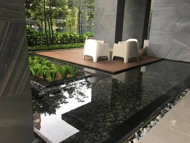 Exterior type: landscape garden; features: wooden deck area, two white outdoor chairs, water feature with reflective surface, pebbled border around water, lush greenery with plants, modern stone cladding, surrounding landscaping, paved walkway; style: modern.