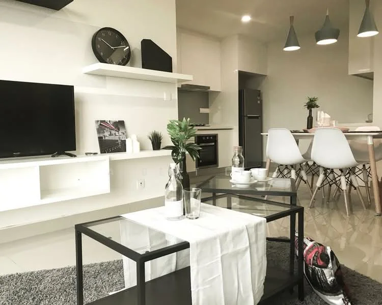 Living features: grey area rug, black coffee table with glass top, white wall-mounted TV console, wall clock, floor-to-ceiling windows, recessed downlights, 2 white dining chairs, dining table, stainless-steel fridge, kitchen cabinetry, black kitchen appliances, green potted plant, decorative items on coffee table; style: modern.