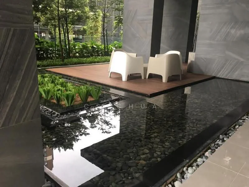 Exterior type: landscape garden; features: wooden deck, two white armchairs, water feature with reflective surface, landscaped greenery, pebble stone border, planter with ornamental grass, grey stone walls, modern architectural design; style: contemporary.