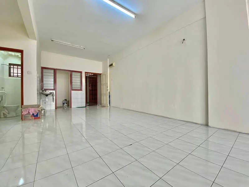 Room features: white painted walls, glossy white tile flooring, fluorescent ceiling lights, open layout, large empty space, no visible furniture, windows with metal grilles, doorway leading to another room; style: minimalist.