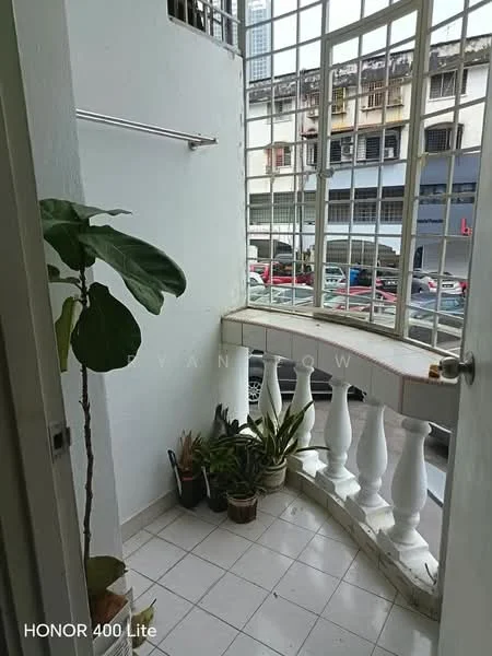Room features: tiled flooring, white painted walls, large windows with grid design, balustrade railing, potted plants, corner space, natural light, view of street; view: street.