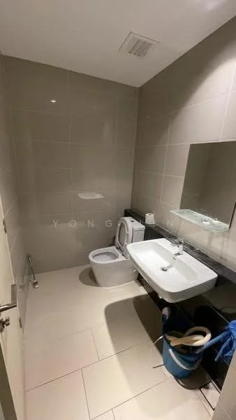 Bathroom features: white tiled walls, cream tiled flooring, single-sink vanity with white countertop, chrome basin mixer faucet, framed mirror, one-piece toilet, wall-mounted toilet paper holder, black granite countertop, blue bucket, cleaning supplies; style: modern.