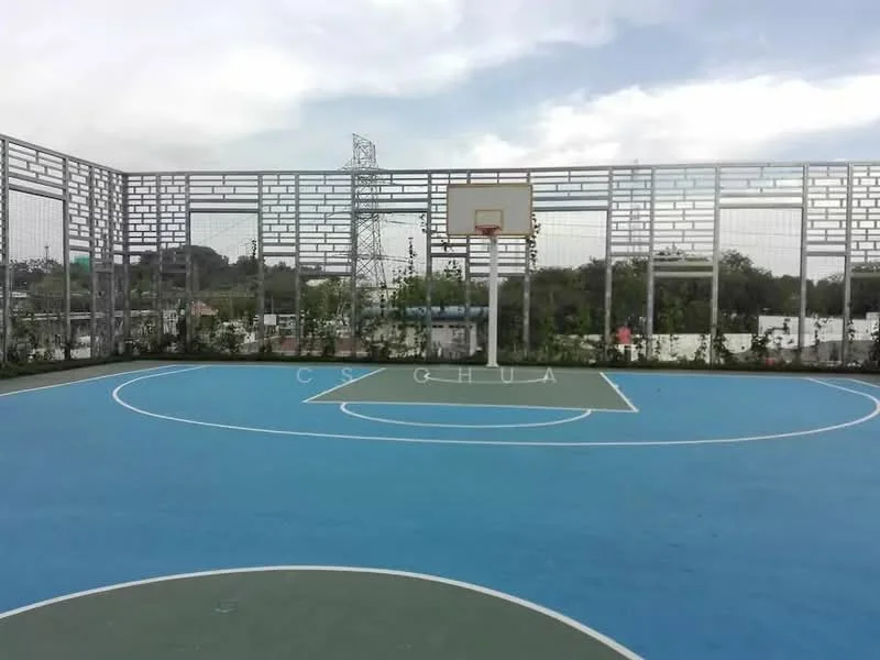 Exterior type: basketball court; features: outdoor basketball court, blue court surface, white boundary lines, basketball hoop, surrounding fencing, landscaped planters, urban backdrop, overhead power lines; style: modern.