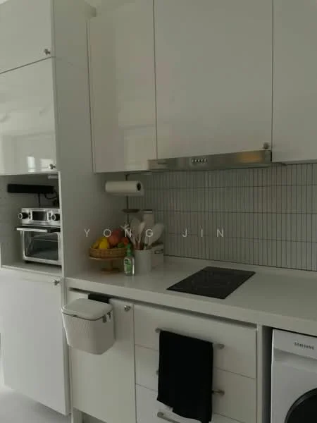 Kitchen features: white cabinetry, stainless-steel countertop, built-in oven, induction cooktop, white tiled backsplash, under-cabinet lighting, basket of fruits, kitchen towel, built-in washing machine, pull-out trash bin, wall-mounted paper towel holder; style: modern.