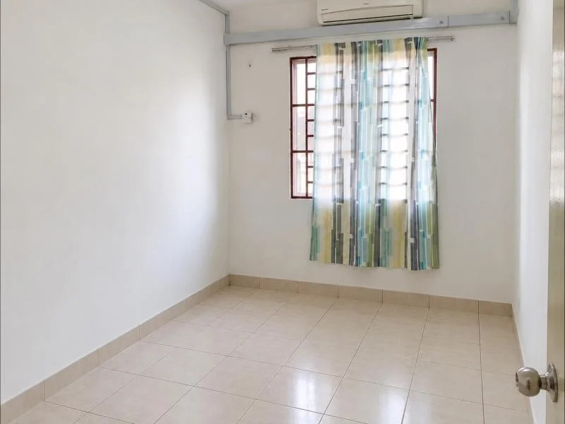 Bedroom features: white painted walls, beige ceramic tile flooring, white ceiling, wall-mounted split air conditioner, sliding window with brown frame, patterned sheer curtains, beige floor skirting, plain white door, metal door knob, electrical conduit on wall, small window grille, empty unfurnished room; style: minimalist.
