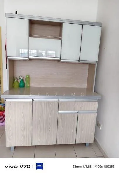 Kitchen features: light wood cabinetry, glass-front upper cabinets, laminate countertop, stainless-steel handles, open shelving, white tiled backsplash, ceramic tile flooring, sink area with faucet, green plastic containers, basket for storage; style: modern.