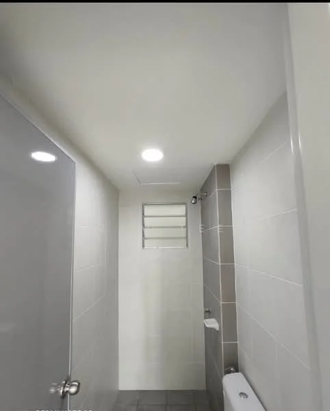 Bathroom features: white tiled walls, grey tiled flooring, recessed LED downlights, glass shower enclosure, toilet, window with louvered design, wall-mounted faucet, built-in shower shelf; style: modern.