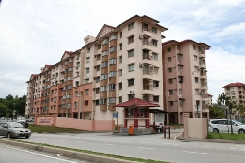 Exterior type: low-rise apartment block; features: pink painted facade, cream painted facade, flat roof, approximately 5-storey, balconies on upper floors, guard house at entrance, paved driveway, landscaped area with plants, parking area visible; style: modern.