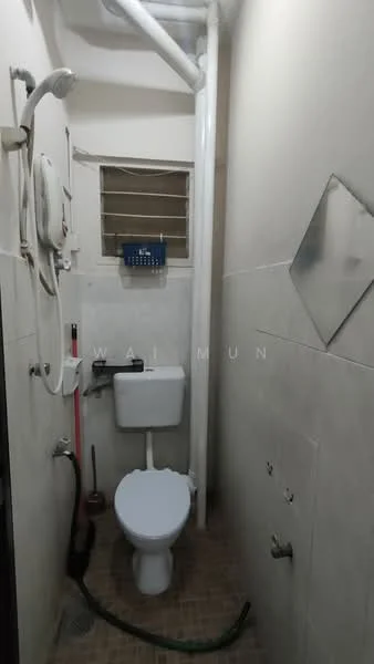 Bathroom features: white toilet, wall-mounted showerhead, handheld shower, tiled walls, tile flooring, mirror, window with metal grille, plumbing pipes visible.