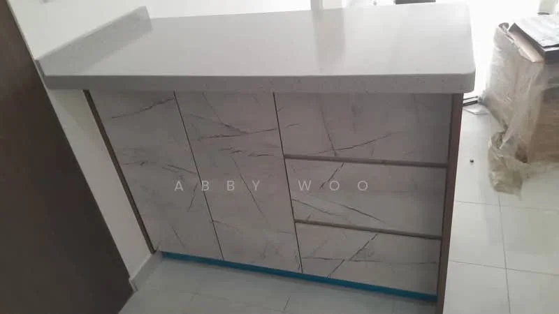 Kitchen features: white quartz countertop with grey veining, cabinetry with marble-patterned laminate finish, four drawers, two cabinet doors, light-colored flooring, minimalist design, no visible appliances, open space layout; style: modern.