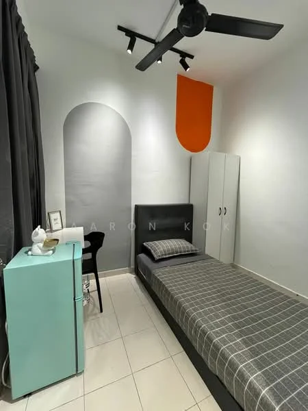 Bedroom features: single bed with grey bedding, black upholstered headboard, grey checkered bedspread, white walls, grey curtains, black chair, white desk, green fridge, white wardrobe, ceiling fan, recessed lighting, decorative orange accent wall; style: modern.