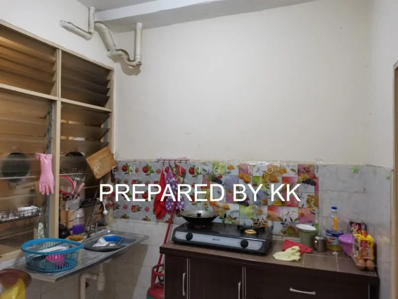 Kitchen features: white painted walls, ceramic tile flooring, stainless-steel gas stove, wall-mounted kitchen cabinets, countertop with tiled backsplash, sink with faucet, open shelving, various cooking utensils, plastic storage containers, baskets for storage, wall-mounted pipes.